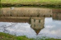 Reflection of Medieval Fagaras fortress in the castle moat. Fagaras, Brasov County, Transylvania, Romania Royalty Free Stock Photo
